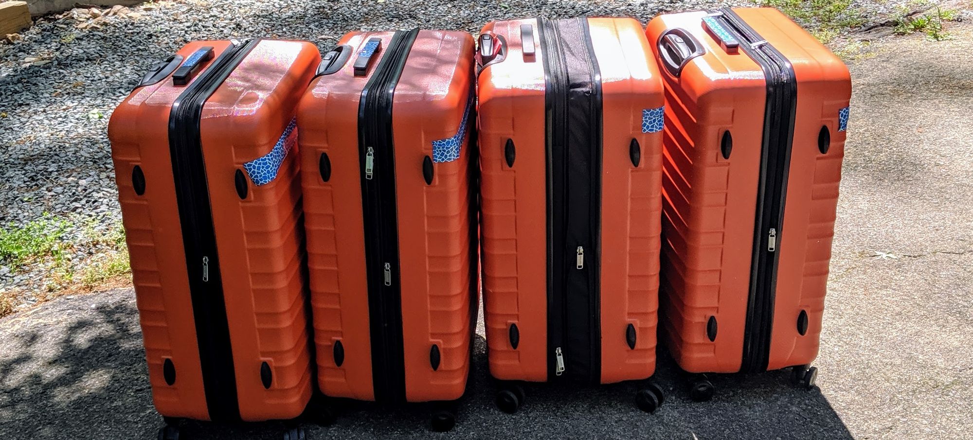 4 Orange Suitcases